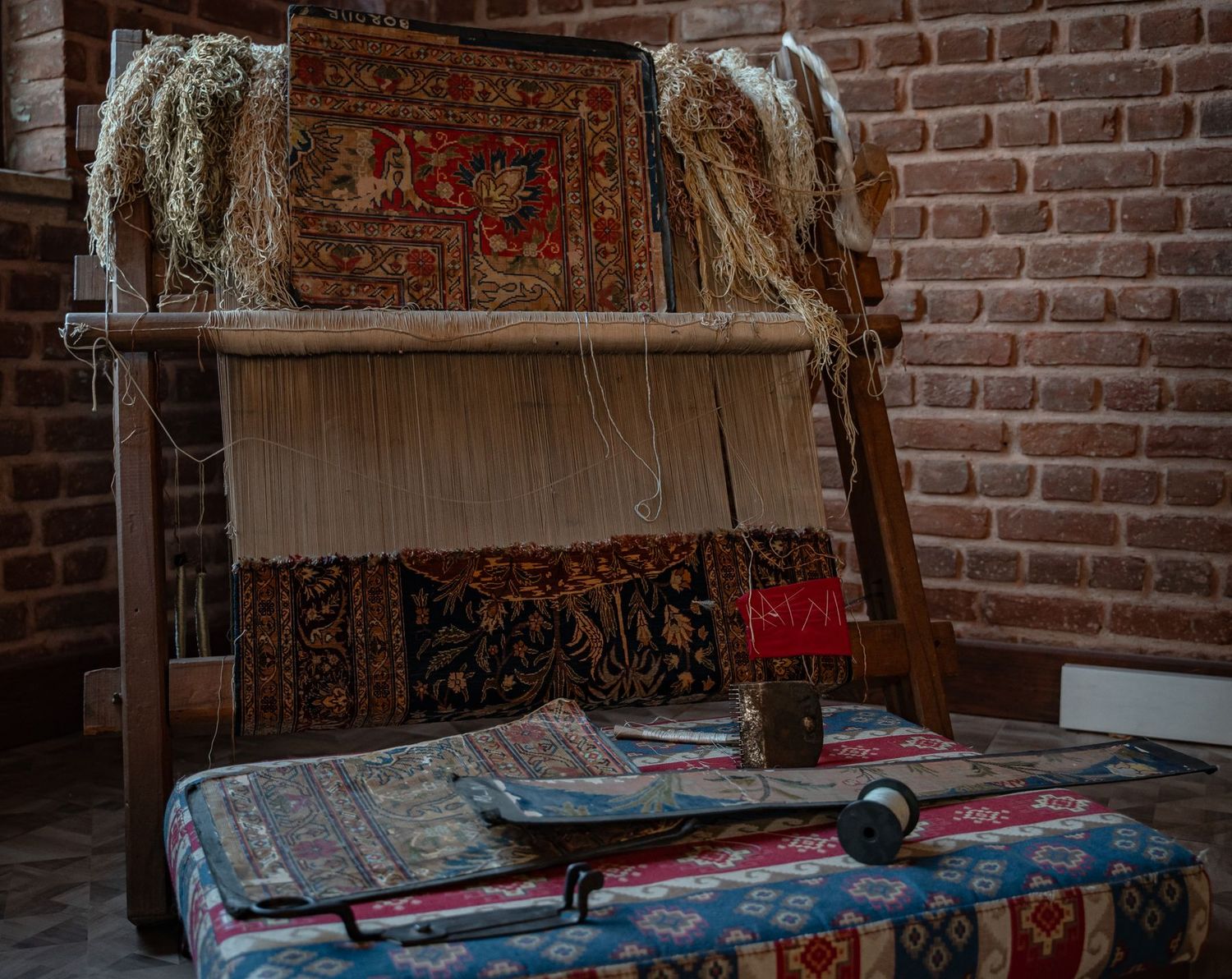 Métier à tisser et tapis en cours de restauration en atelier