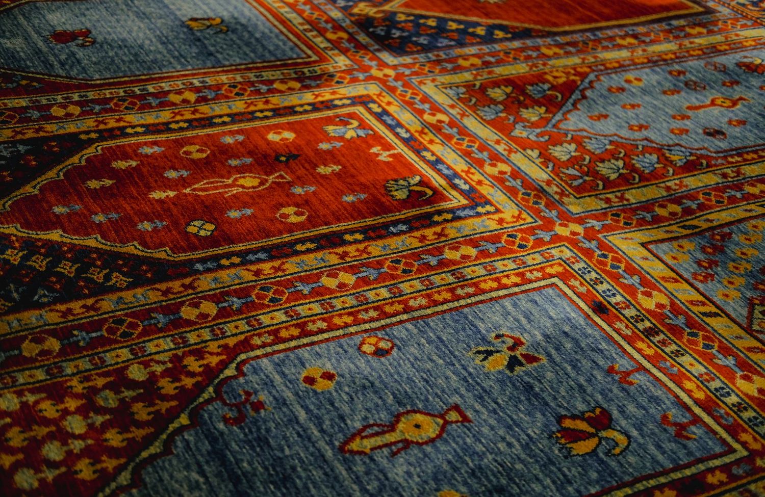 Tapis ancien en laine nouée main à motifs géométriques bleus et rouges